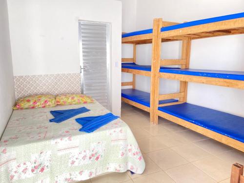 a bedroom with a bunk bed and blue bunk beds at Guarajuba sitiofelizcidade in Guarajuba