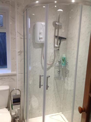 a shower with a glass door in a bathroom at JOE'S PLACE in Retford