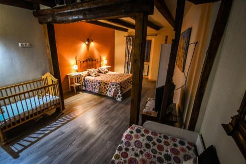 a view of a bedroom with two beds and a crib at aCienLeguas in Castrojeriz