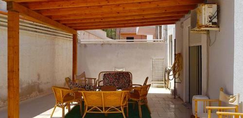 a patio with a table and chairs on a porch at Casa O'Scia in Lampedusa