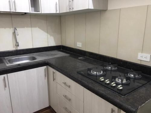 a kitchen with a stove and a sink at CRUCITALIA suite x 4 in Crucita