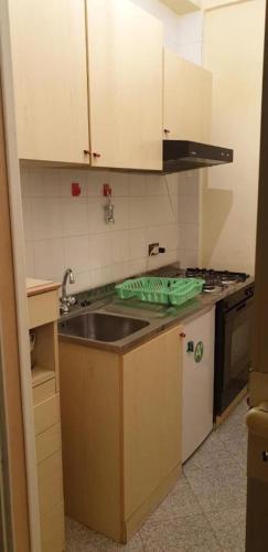 a small kitchen with a sink and a stove at Casa O'Scia in Lampedusa
