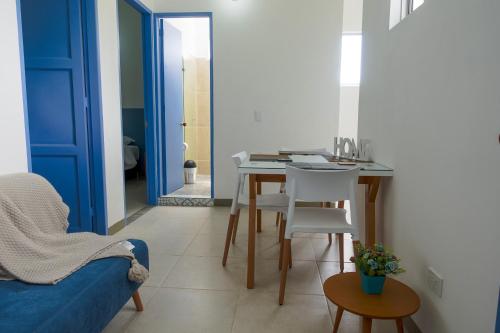 a living room with a table and a blue door at Hotel Azulado Jericó in Jericó
