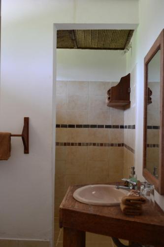 a bathroom with a sink and a mirror at Emerald Bay Resort in Kizungu
