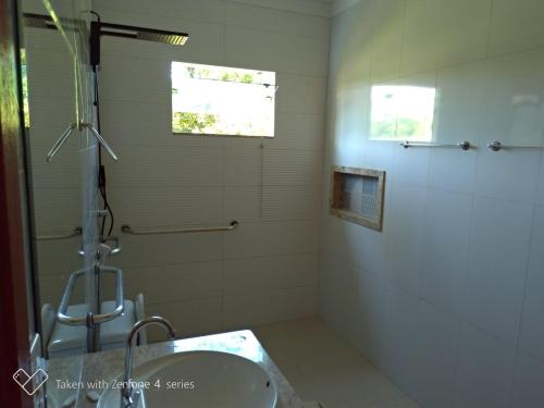 a bathroom with a shower and a sink at HOTEL PRAIA DA PAIXÃO in Prado