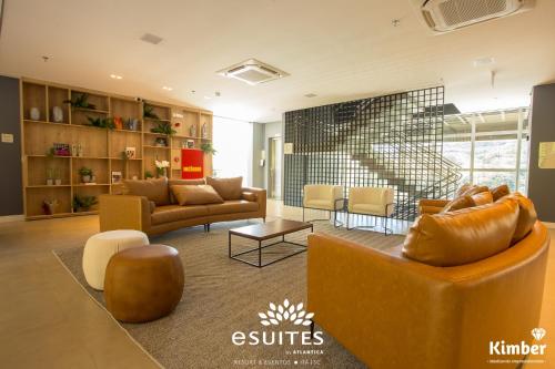 a living room with a couch and a table at Grand Suítes Family Resort by Atlantica in Itá