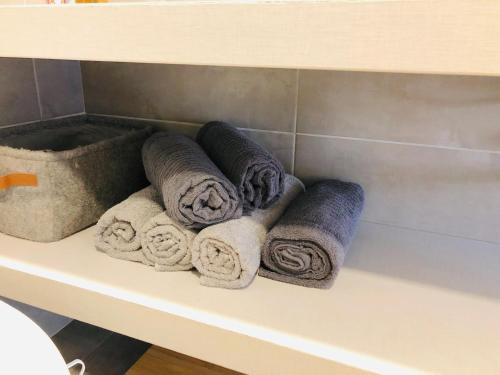 a bunch of towels sitting on a shelf in a bathroom at House 3 Bedroom Vilnius in Vilnius