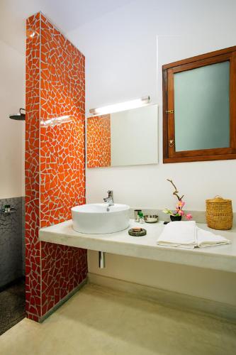 a bathroom with a sink and a mirror at Villa Shanti - Heritage Hotel for Foodies in Puducherry
