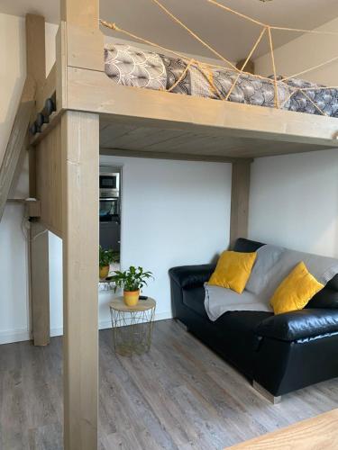 a living room with a couch and a loft bed at Studio cocoon in Amboise