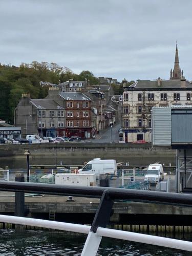 a view of a marina with cars and buildings at Our Wee Getaway in Rothesay