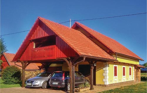 a house with two cars parked in front of it at Three-Bedroom Holiday Home In Gradac in Gradac