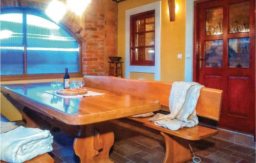 a wooden bench with a table and a bottle of wine at Three-Bedroom Holiday Home In Gradac in Gradac