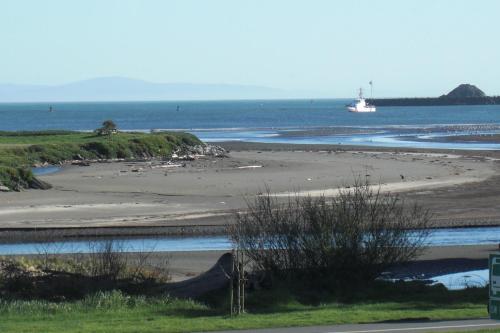 a view of a beach with a boat in the water at Front Street Inn in Crescent City