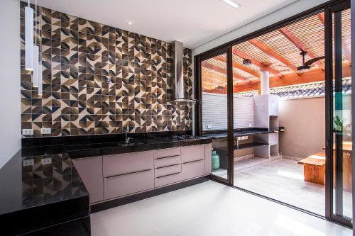 a kitchen with a sink and a large window at Residencial Marina Del Sol in Pauba
