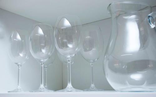 a row of wine glasses sitting next to a vase at Residencial Marina Del Sol in Pauba