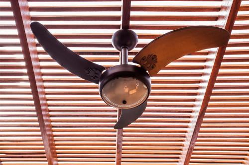a ceiling fan with two knives hanging from a ceiling at Residencial Marina Del Sol in Pauba