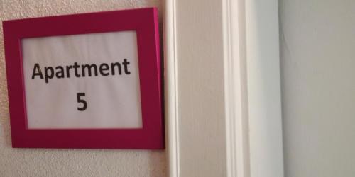 a sign on a door that reads apartment at Book-A-Room Salzburg Apartment 5-6-7-8 in Salzburg
