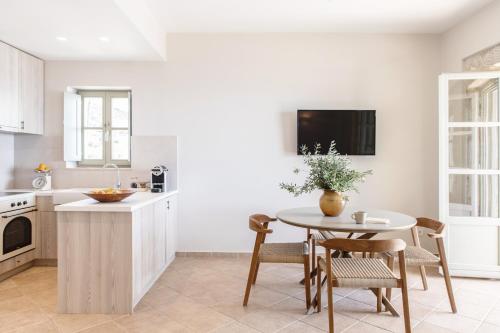 a kitchen with a table and chairs and a sink at Amani Living in Stoupa