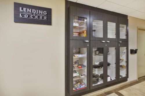 a library with wooden cabinets and a sign on the wall at Candlewood Suites Morgantown-Univ West Virginia by IHG in Morgantown