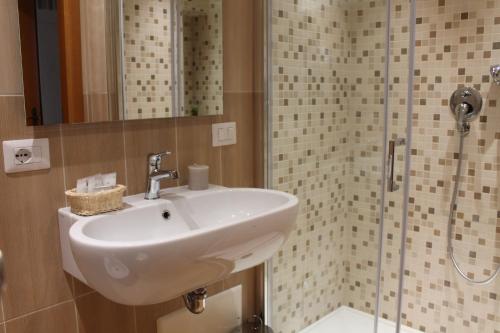 a bathroom with a sink and a shower at Hotel Mediterraneo in Roccella Ionica