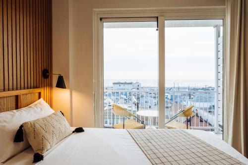 a bedroom with a bed and a large window at The Rockaway Hotel in Queens