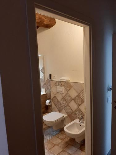 a bathroom with a toilet and a sink at Il Vicolo in Lucca