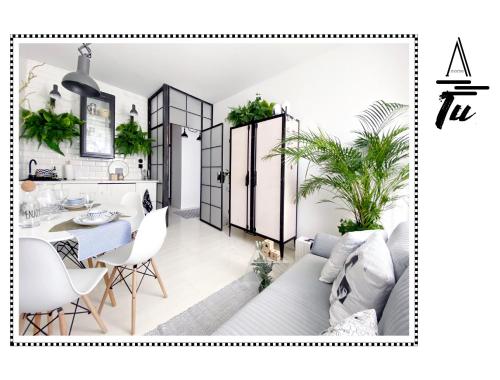 a living room with a couch and a dining room at A morze TU in Gdynia