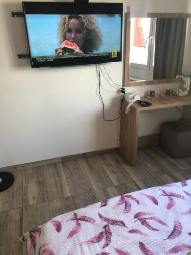 a flat screen tv hanging on a wall in a room at Prishtina Newborn ABC room in Pristina