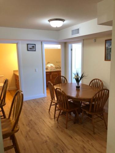 a dining room with a wooden table and chairs at Muskoka Lakes Hotel and Resorts in Port Carling