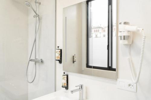 a bathroom with a shower and a sink with a mirror at Bidaia Boutique Hotel in San Sebastián