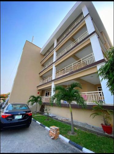 a car parked in front of a building at WATER VIEW 3 BEDROOM APARTMENT WITH JACUZZI PARKING WiFi NETFLIX POOL in Lekki