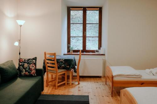 a living room with a couch and a table and chairs at Zamkowa, Pokoje Gościnne in Kazimierz Dolny