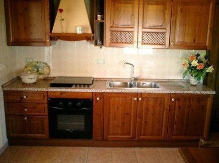 a kitchen with wooden cabinets and a sink at Villa Primavera in Villa San Pietro