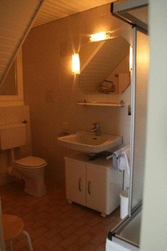 a small bathroom with a sink and a toilet at Pension Seevilla Annelies in Maria Wörth