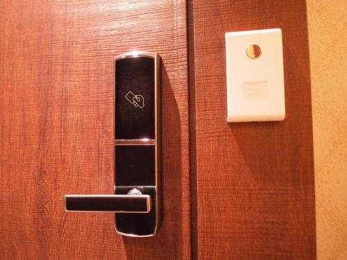 a door with a black handle on a wooden door at Hotel Four Seasons in Jeju