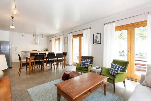 a living room with a table and chairs at Solomon Street Cottage in Fremantle