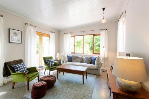 a living room with a couch and chairs and a table at Solomon Street Cottage in Fremantle