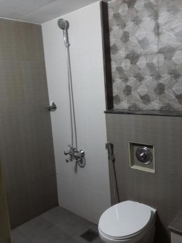 a bathroom with a toilet and a shower at M3 Homes in Munnar