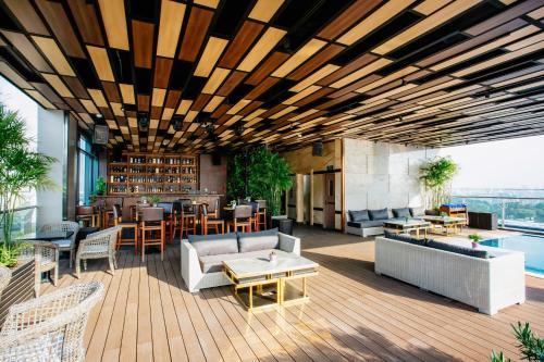 a patio with furniture and a bar on a building at Northern Charm Hotel in Ho Chi Minh City