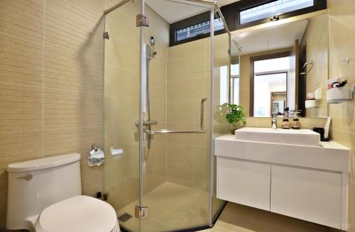 a bathroom with a shower and a toilet and a sink at Vinhomes Skylake Hanoi - CitiHome in Hanoi