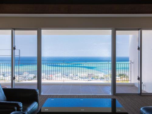 a living room with a view of the ocean at Condominium T-Room in Jima
