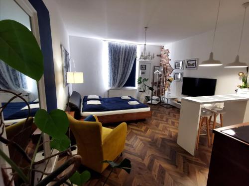 a living room with a bed and a desk in it at Apartamenty Orkana in Bielsko-Biała