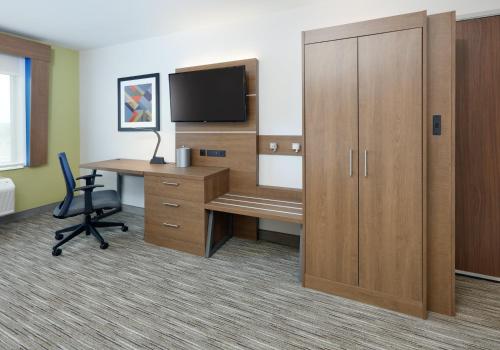 an office with a desk and a tv and a cabinet at Holiday Inn Express & Suites San Antonio NW near SeaWorld by IHG in San Antonio