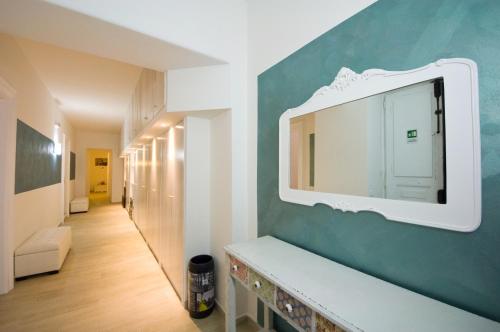 a bathroom with a mirror on a blue wall at Atlantis Inn Roma in Rome