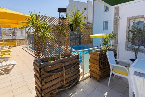 a patio with a pool and a table and chairs at Hola Bodrum in Mugla