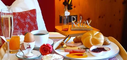 a table with a plate of food and eggs and drinks at Hapimag Ferienwohnungen Zell am See in Zell am See