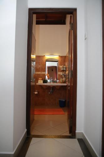 a doorway to a bathroom with a shower and a sink at Colombo Orchid Villa in Colombo
