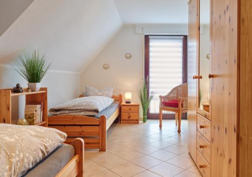a bedroom with two beds and a table and a chair at Ferienhaus Götten in Hontheim