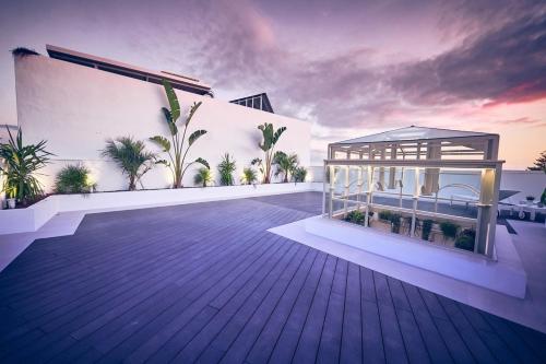 a rendering of a balcony of a building with a gazebo at La Casa del Arco in Conil de la Frontera
