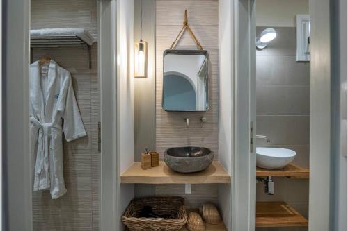 a bathroom with a sink and a mirror at Luxury Apartment in the Heart of Astypalaia in Astypalaia Town